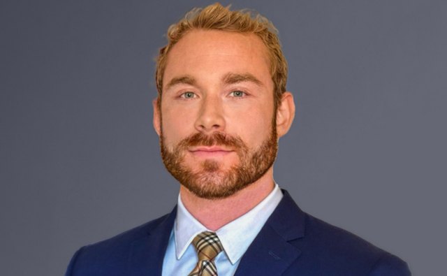 Christian — founder of Christian Trades Live, in a navy suit and tie